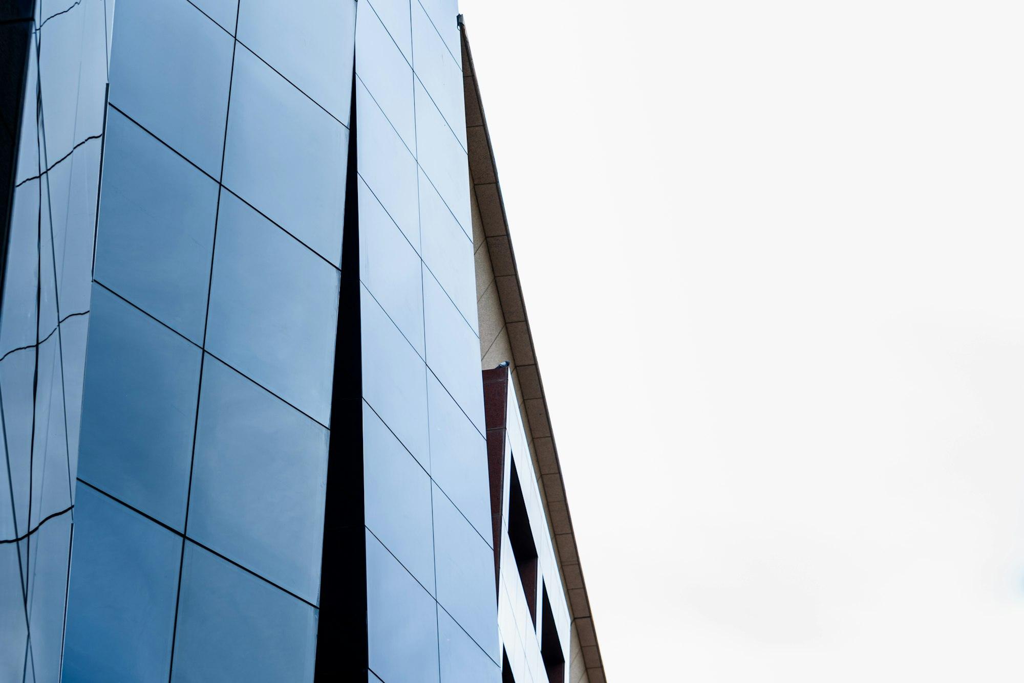 Glazed building with reflections where the working middle class aspires to buy residences